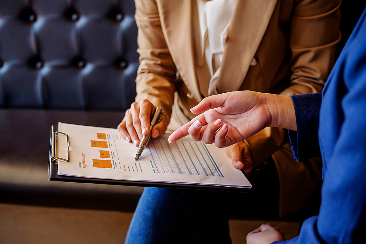 This image of a person explaining a financial chart to client represents findings from new CSA research on what investors think and know about fees, and how they interact with advisors.