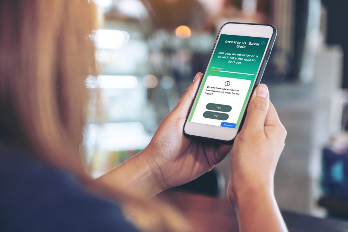 The purpose of this image of a woman holding her smartphone is to show British Columbians what the BCSC InvestRight Investor vs. Saver Quiz looks like, and how easy it is to access on any smart device.