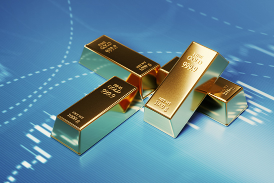 This image of four gold bars sitting on top of an investment chart shows how investors may fall back to gold or other precious metal investments during market volatility, and fraudsters will try to take advantage of that and offer up gold scams.