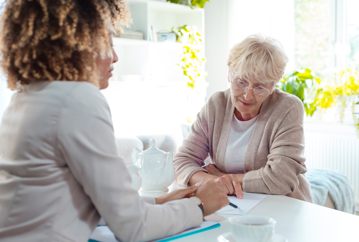 The image is meant to show an older adult experiencing elder financial abuse.