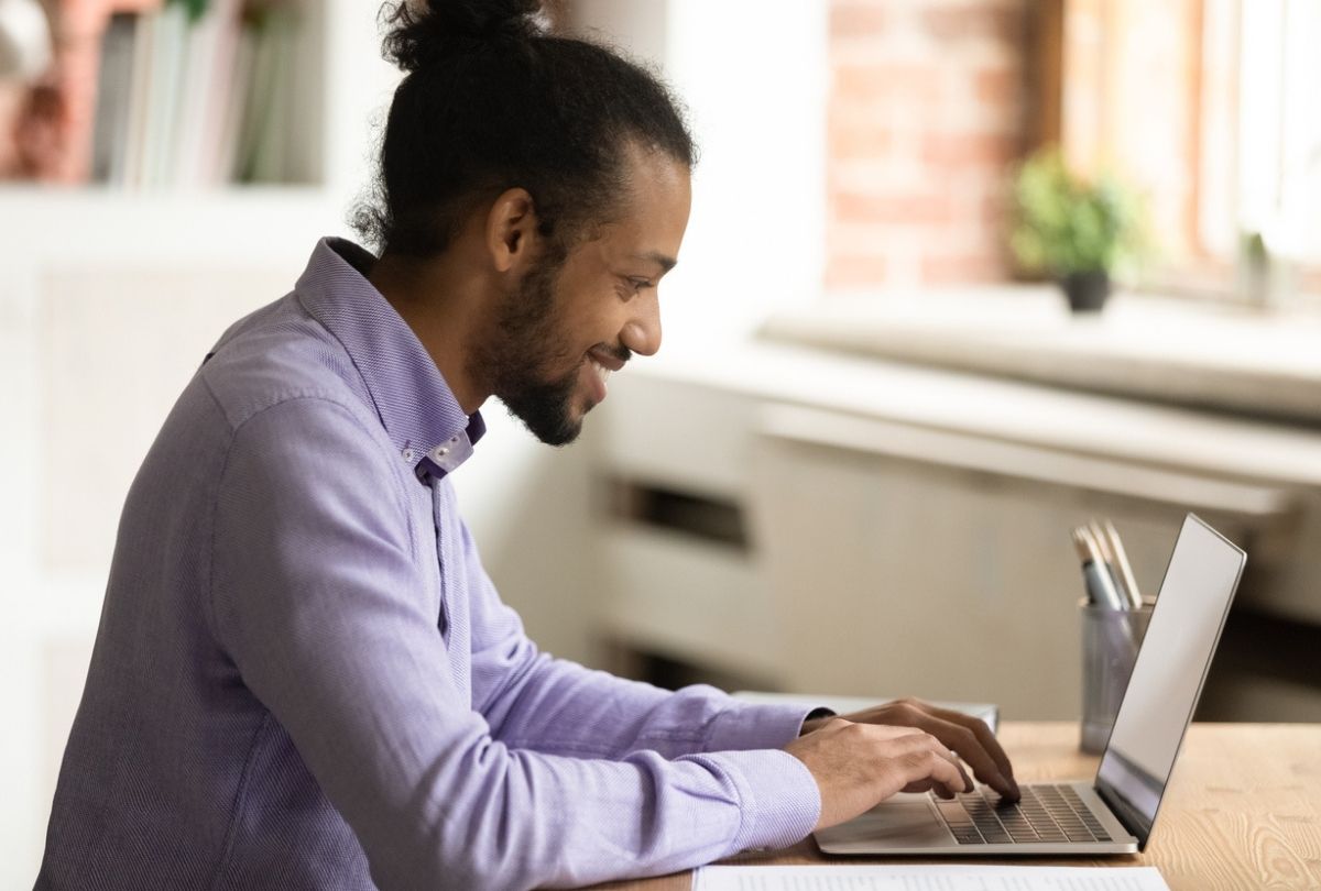 A young man is sitting at the computer desk and testing his knowledge of crypto assets with the BCSC InvestRight's new Crypto Quiz.