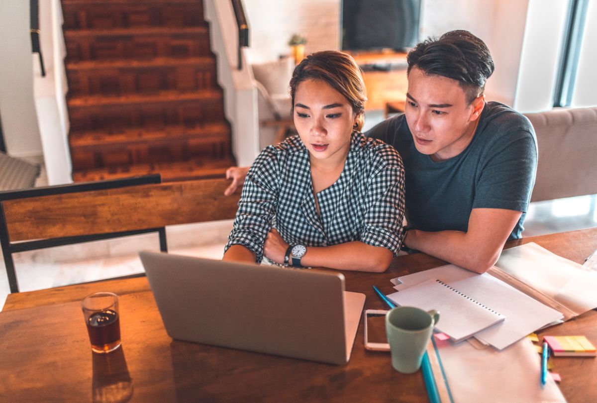 A young couple discussing their financial goals as they plan to open and contribute to an RRSP