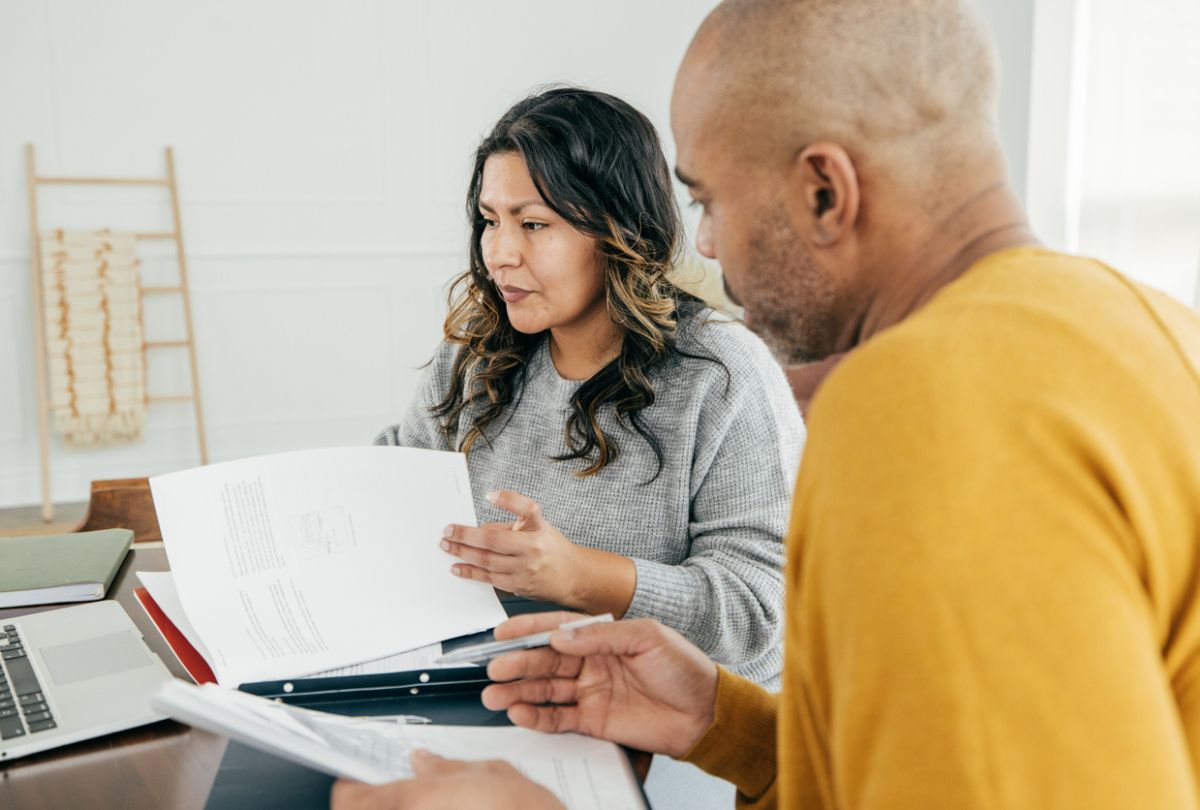 A couple researching about how to seek financial compensation from an investment firm