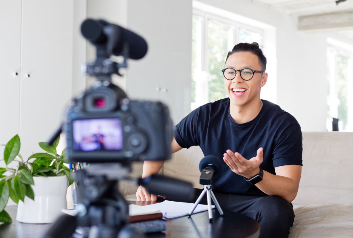 A young man recording himself with a camera